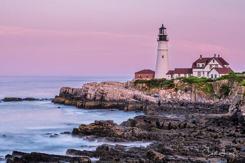 An image of Portland Head lighthouse in Maine at sunset.
