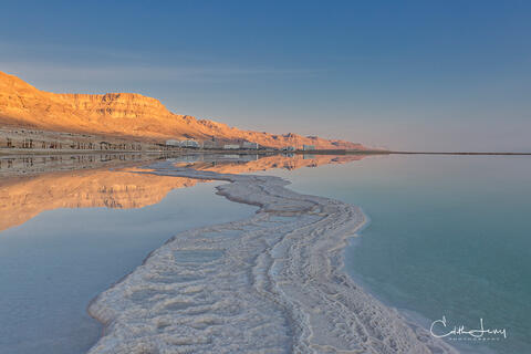 Sunrise at the Dead Sea in Israel with salt formations leading the eye to infinity.