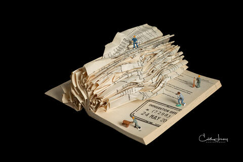 Fine art photo of an abstract folded book, featuring miniture figures forming geometric patterns , created by Toronto based photographer, Edith Levy