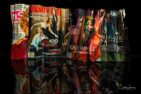 Fine art photograph of folded fashion magazines including Vanity Fair, In Style, Vogue and Town & Country